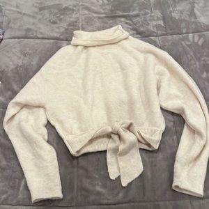White Aritzia sweater with tie in front